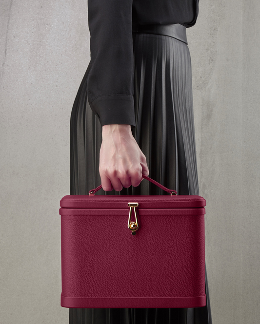 Atelier Verdi medium pink leather vanity case held by model